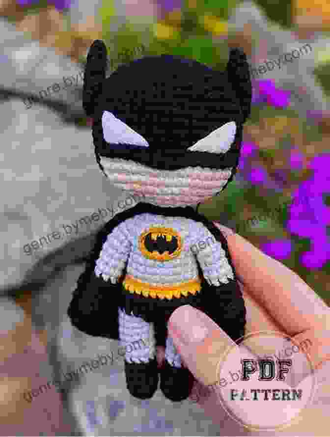 A Detailed View Of The Crocheted Batman Amigurumi, Showcasing The Carefully Crafted Bat Symbol, Grappling Hook, And Batarangs. Crochet Batman Pattern